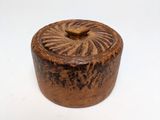 a close up of a small wooden box on a white surface