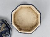 two small blue and white dishes sitting next to each other on a table
