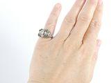 a woman ' s hand with a diamond ring on it