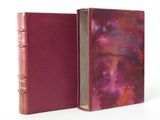 an open book with a pink cover and a red cover