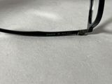 a pair of glasses sitting on a table next to a pair of glasses