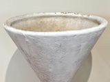 a white vase that is sitting on a table