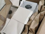 a cardboard box with a white refrigerator inside of it