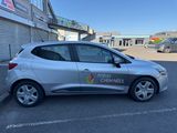 a silver car parked in a parking lot next to a building