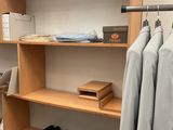 a closet with a lot of clothes and shoes on the shelves