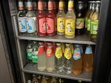a small refrigerator filled with bottles of alcohol and drinks
