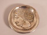an image of a silver coin with a woman ' s face on it