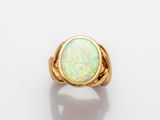 a yellow gold ring with an oplite stone in the center