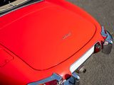 a close up of a red car with its hood open
