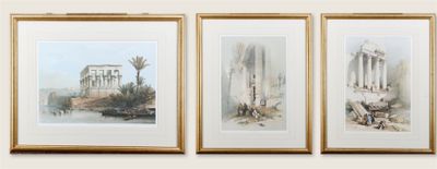 trois tableaux encadrés représentant des ruines antiques et des palmiers, accrochés au mur