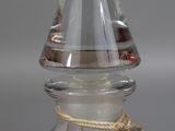 a clear glass bottle with a rope around it