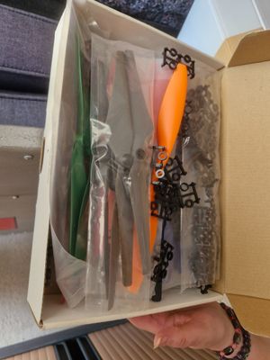 someone is holding a box with a bunch of tools inside of it
