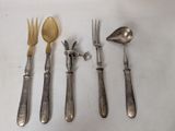 four forks, a spoon, and a knife on a table
