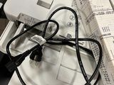 a white box with a black cord and a white box with a black cord and a white box with a black cord and a white box with a black