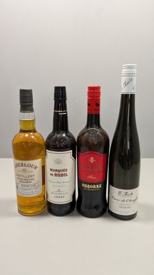 quatre bouteilles de vin sont alignées sur une table