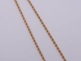 a gold chain necklace with a long link on a white background
