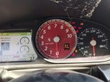 a car dashboard with a clock and a cell phone in it