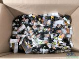 a cardboard box filled with bottles of alcohol and other things