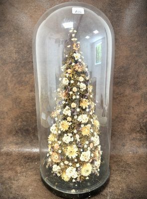a glass cloche with a christmas tree inside of it