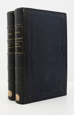two black books sitting on top of each other on a white surface