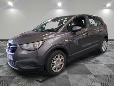 a picture of a grey car parked in a garage