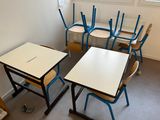 a room with several tables and chairs in it