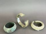 three pieces of pottery sitting on top of a table next to each other