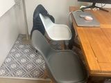 a desk with a chair and a computer on it