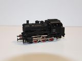 a toy train on a white surface with a white background