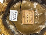 a close up of a gold vase with a label on it