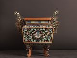 a small wooden cabinet with a floral design on it