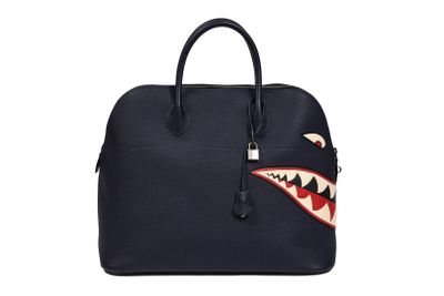 a sharky handbag with a zipper on the front and a sharky mouth on the side