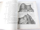 an open book with a picture of a mountain in it