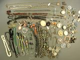many different types of necklaces and bracelets laid out on a table