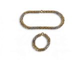 two gold and silver bracelets and a ring on a white background