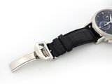 a watch that is sitting on a black leather strap