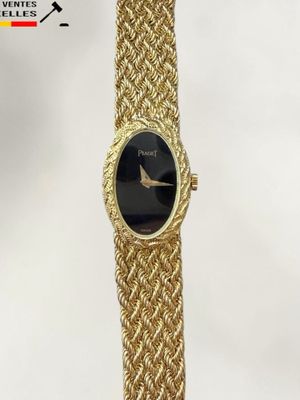 a gold bracelet watch with a black face and a gold chain strap