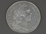 une vieille pièce d'argent portant une tête de femme