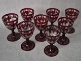 six wine glasses are lined up in a row on a table