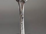 a fork that is sitting in front of a group of silver spoons