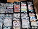 many boxes of glasses and pens on the table