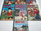 several children ' s books are lined up on a white surface