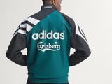 the back of a man in a green jacket and black pants
