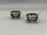 a pair of silver plated earrings with a lion head on them