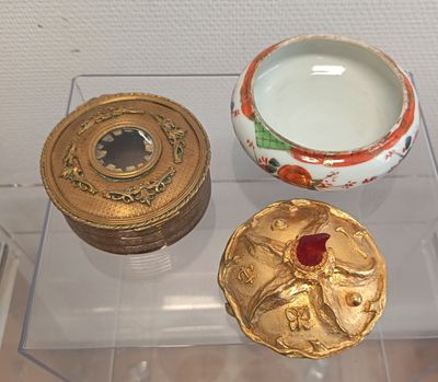 a glass display case with three different items on it