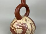 a brown and white vase with a bird on it