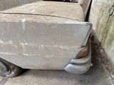an old car that is sitting on the side of the road