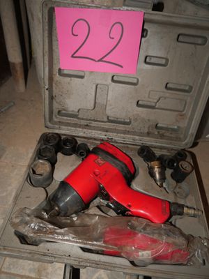a red cordless drill in a case with a pink sticker on it