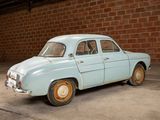 a small blue car parked in front of a brick wall