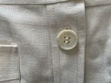 a button on the back of a white shirt